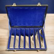 Seven harmonicas in a fitted case.