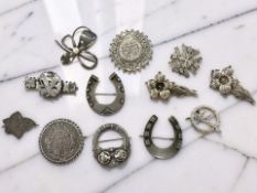 A group of 19th century and later silver brooches, including horseshoe, Celtic, and floral examples,
