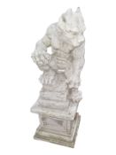 A concrete ogre figure on plinth, height 77 cm.