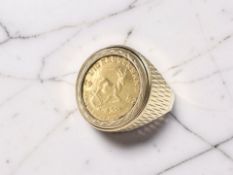 A 9ct yellow gold ring, set with a 1/10 ounce 1982 Krugerrand, size N.