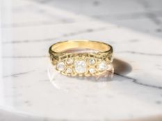 An 18ct yellow gold seven stone diamond ring, central old cut cushion shaped diamond approx. 0.