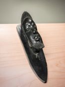An African carved ebony wall plaque depicting a male figure,