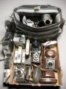 A collection of vintage film cameras and later digital cameras including Balda, Canon, Yashica,