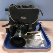 A Canon T90 film camera, with Canon Zoom FD 28-85mm 1:4 lens, instruction manual and a camera bag.