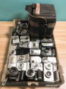 A collection of digital cameras including Canon, Fujifilm, Olympus, Sony Walkman, etc.