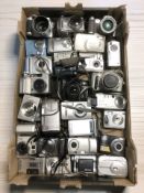 A collection of digital cameras including Canon, Fujifilm, Olympus, Sony Walkman, etc.