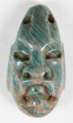A pre-Columbian amazonite amulet, carved with a jaguar transformation mask and pierced for