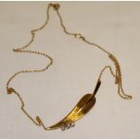 An 18ct gold necklace with leaf-shaped pendant mounted with three diamonds (5.