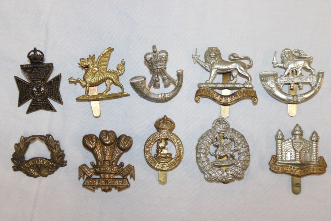 A selection of various military cap badges including the Leinster ...