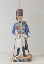 A finely carved and decorated wooden figure 5.5" of a. Officer of the 7th. Hussars 1807 in full