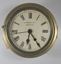 A brass Bulkhead Clock diameter 7.5", depth 4", by "J Foxall & Co. Newport", white dial with roman
