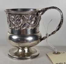 A George IV silver Christening Mug, height 3" with floral and foliate repousse decoration and
