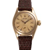 A LADY'S 18K SOLD GOLD ROLEX OYSTER PERPETUAL WRIST WATCH CIRCA 1963, REF. 6504 WITH 