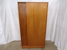Uniflex mid century teak wardrobe having a single door opening to five shelves and a hanging rail,