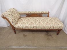 Hardwood chaise longue having foliate design upholstery, standing on turned legs terminating in