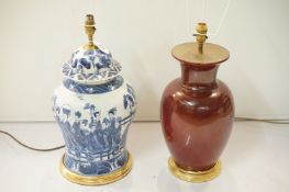 Two Chinese porcelain lamp bases, one in the form of a blue and white temple jar, the other a sang