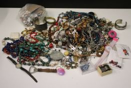 Large quantity of costume jewellery comprising beaded earrings, a Superdry watch, a yellow metal