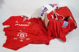 Adidas Manchester United jumper together with a Manchester United Red Devils knitted scarf and a