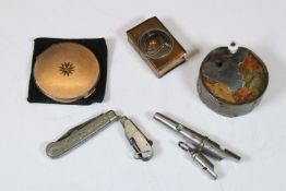 Early 20th century Acme triple whistle, a Stratton powder compact, an early 20th century brass