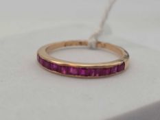 A ruby half eternity ring 14ct gold size N 1.6 gms