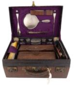 λ An early-20th century travelling crocodile toilet case, retailed by The Army & Navy Store Co-