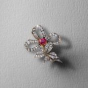 A VICTORIAN RUBY AND DIAMOND BOW BROOCH / PENDANT, C1890, centring on a cushion-shaped ruby weighing
