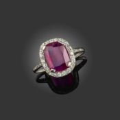 AN EARLY 20TH CENTURY RUBY AND DIAMOND RING, C1910, the cushion-shaped ruby weighing 4.19cts, set