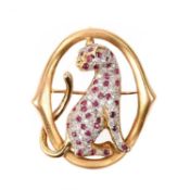 A RUBY AND DIAMOND BROOCH/PENDANT, centred with the figure of a seated panther, its body pavé-set