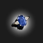 CARTIER, A SAPPHIRE AND DIAMOND RING, set with an oval sapphire flanked with pear-shaped diamonds in