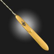 A LATE 19TH CENTURY BRUSHED GOLD LETTER OPENER, decorated with a fleur-de-lys set with an oval