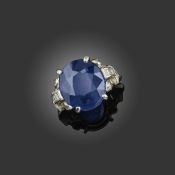 A SAPPHIRE AND DIAMOND RING, C1930, set with an oval-shaped sapphire weighing 8.20cts, within