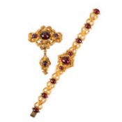 A VICTORIAN GARNET BRACELET AND BROOCH, the bracelet set with graduated garnet cabochons in yellow