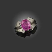 MAUBOUSSIN, AN ART DECO RUBY AND DIAMOND RING, the oval ruby weighing approximately 2.80cts, in