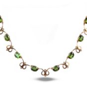 A TOURMALINE AND DIAMOND NECKLACE, composed of claw-set oval-shaped tourmalines alternating with