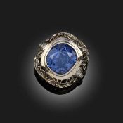 A SAPPHIRE AND DIAMOND DRESS RING, the cushion-shaped sapphire weighing 13.09cts set within