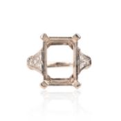 A DIAMOND-SET RING MOUNT, with vacancy for a rectangular-cut stone with diamond shoulders in