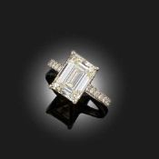 A DIAMOND SOLITAIRE RING, set with an emerald-cut diamond weighing 5.03cts, in a round brilliant-cut