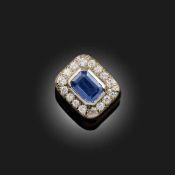 A SAPPHIRE AND DIAMOND CLUSTER RING, set with a step-cut sapphire weighing 2.385cts, within a