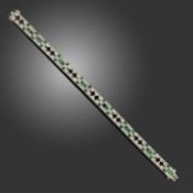 MAUBOUSSIN, AN ART DECO EMERALD AND DIAMOND BRACELET, C1927, of geometric design set with emerald-