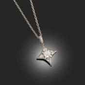 AN EARLY 20TH CENTURY DIAMOND-SET PENDANT NECKLACE, in the form of a star, set with a circular-cut