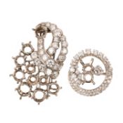 TWO DIAMOND-SET BROOCH MOUNTS, comprising; a brooch mount of cornucopia form, the basket set with