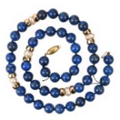 A LAPIS LAZULI BEAD NECKLACE, accented with gold rondels and freshwater cultured pearls, on a gold