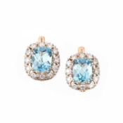 A PAIR OF BLUE TOPAZ AND DIAMOND EARRINGS, each set with a mixed-cut blue topaz within a pierced