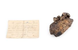 A silver ingot, length 5.5cm, with an accompanying handwritten note ' The first produce from Mr