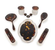 λ A matched silver-mounted tortoiseshell dressing table set, mainly by Mappin & Webb, London 1922,