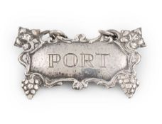 By Omar Ramsden, an Arts & Crafts silver wine label, London 1937, shaped rectangular form with a