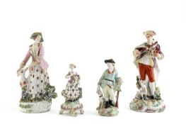 TWO DERBY FIGURES C.1760-70 he standing holding a basket of fruit and flowers, she with a hound at