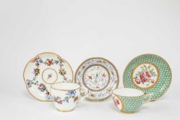 A SEVRES CUP AND SAUCER C.1795 painted with a pink rose spray inside a green and gilt 'fond