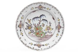 A DELFTWARE CHARGER ENGLISH, MID-18TH CENTURY polychrome painted with a chinoiserie rock garden
