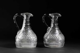 A PAIR OF CUT GLASS CLARET JUGS C.1820 each of broad mallet form, with a three-ring neck, bands of